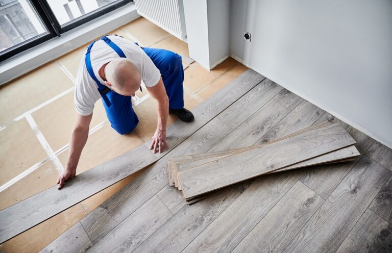 Top,View,Of,Male,Construction,Worker,Laying,Laminate,Wooden,Planks