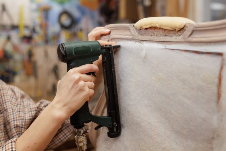 Close-up,Of,Hands,Using,A,Pneumatic,Stapler,To,Attach,Padding