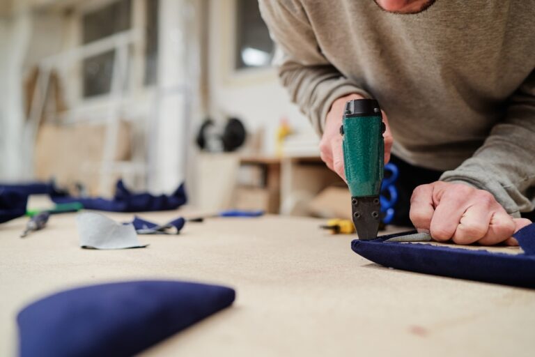 Craftsman,Carefully,Works,On,Upholstery,Fabric,Using,Professional,Tools,,Showcasing