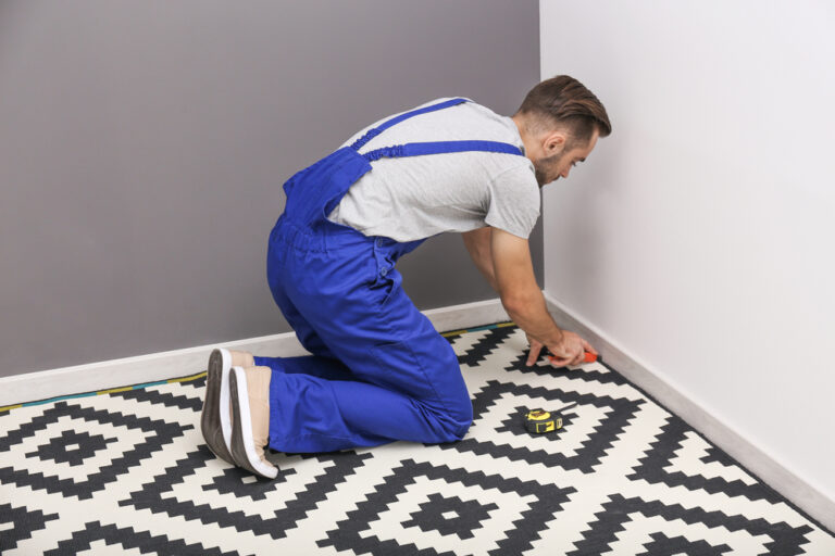 Male,Worker,Fitting,Carpet,On,Floor,Indoors